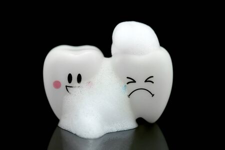 Tooth smile and cry with emotion toothpaste foam on a black background.の写真素材