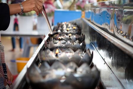 Woman's hand Are fueling lampsの写真素材