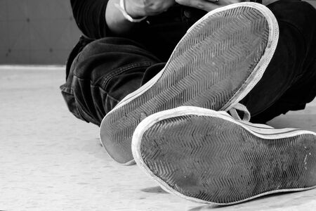 The shoes of the men sitting on the floor.の写真素材