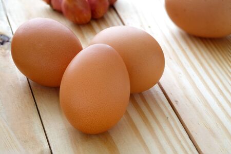 Eggs on wooden table with selective focus