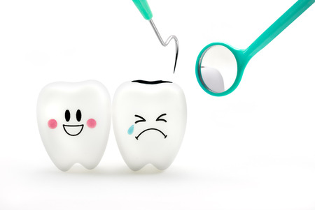 Teeth smile and crying emotion with dental mirror and dental plaque cleaning tool isolated on white background, With clipping path teeth and toolの写真素材