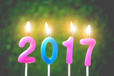 Decoration Candles, Merry Christmas and Happy New Year 2017 on green background