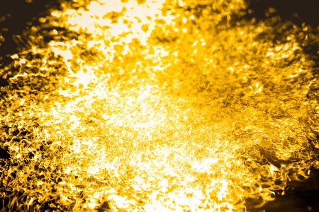 Abstract background liquid gold flowing quickly.の写真素材