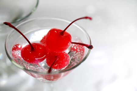 Sparkling water or soda in a glass with a cherry.の写真素材