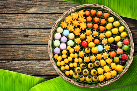 Dessert of Thailand Arranged in a wicker basket on the wooden floor with banana leaves.の写真素材