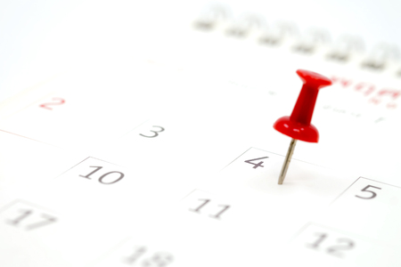 Embroidered red pins on a calendar on the 4th July with selective focus, independence dayの写真素材
