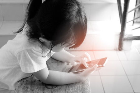 Asian child girls are addictive playing mobile phones, Game Addictionの写真素材