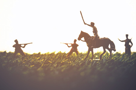 The silhouette of a soldier with a gun on grass and a white background.の写真素材