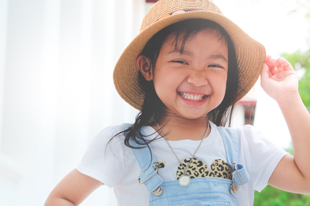 asian child girl smiling brightly with happiness.の写真素材