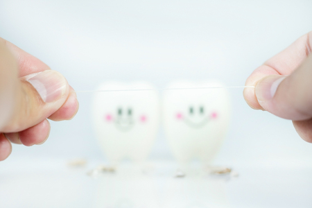Hand of man holding Dental floss with blur Teeth smile and crying emotion ,Concept Dental care cleaning  bacterial plaqueの写真素材