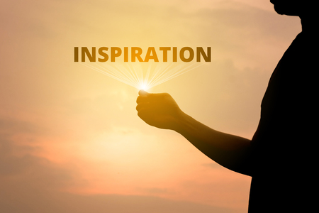 Men's silhouette concept opens a beam of inspiration text on the golden skyの写真素材