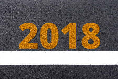 New year 2018 and white lines on the asphalt road surface background texture