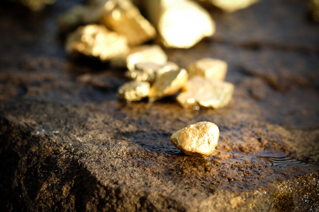 The pure gold ore found in the mine on a stone floorの写真素材