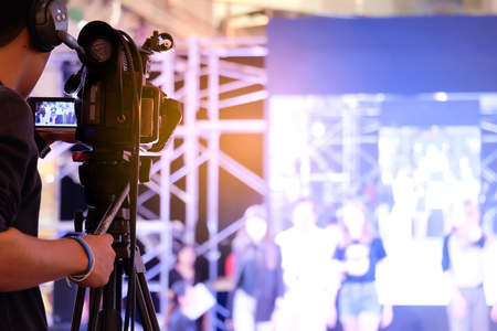 Photographer video recording activity within the event on Stage