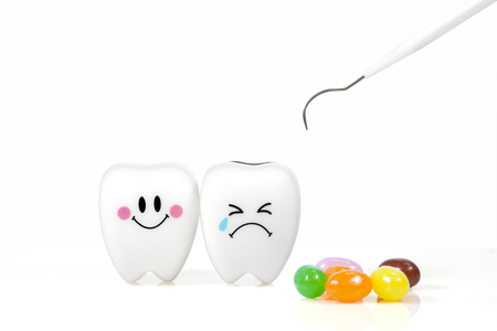 Teeth smile and crying emotion with dental plaque cleaning tool and candy isolated on white background, With clipping pathの写真素材