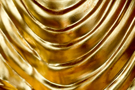 Abstract gold background, glossy metal that is a luxurious fabric is waveの写真素材