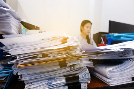 Many documents on the employee's desk with selective focusの写真素材