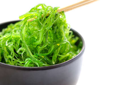 Hiyashi Wakame Chuka or seaweed salad in black bowl on white background ,Japanese foodの写真素材
