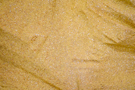 Foam sandstone loosening golden stone abstract background texture