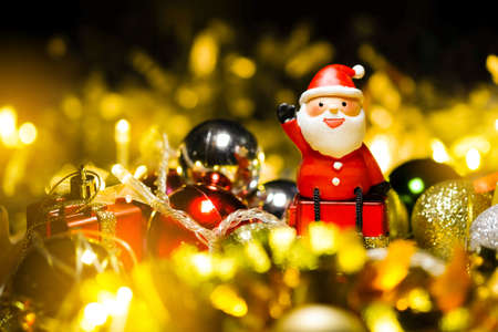 Santa Claus dolls and Christmas decorations on abstract light background with copy spaceの写真素材