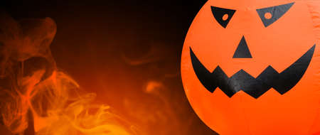 Pumpkin head doll on a black background with smoke with copy space for, Halloween Concept