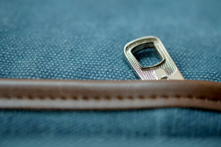 Close up the metal zipper of the blue backpack or jeans