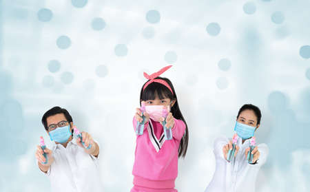 Asian families are strong in defeating the virus by wearing a mask and carrying alcohol bottles for...