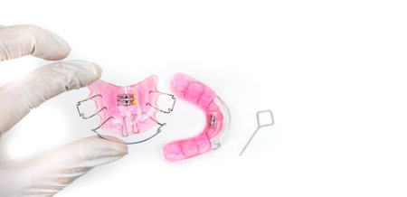 Doctors are holding a dentist, removable braces for children with crooked teethの写真素材