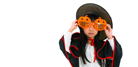 Asian girl dress up in witch costume wearing glasses halloween theme isolated on white background with clipping pathの写真素材