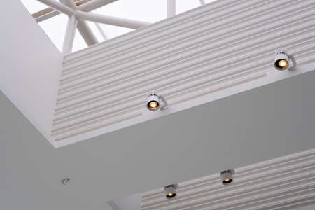 Interior downlight on the ceiling of a white building