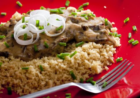 beef meat with mushroom sauce on couscousの写真素材