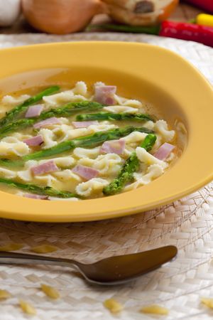 vegetable bouillon soup with asparagus and hamの写真素材