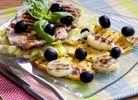 grilled pork steak with potatoes and onionsの写真素材