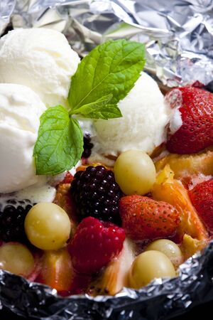 warm fruit salad with ice creamの写真素材