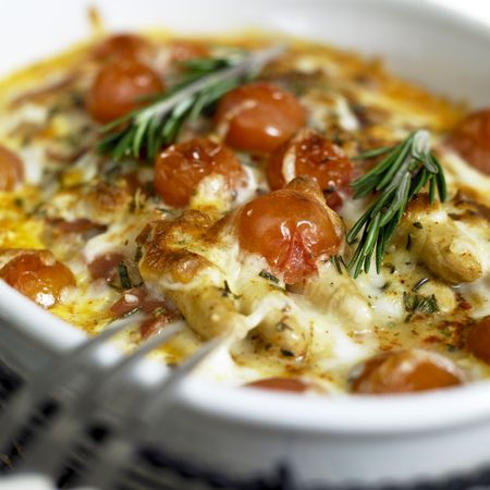 baked white asparagus with cherry tomatoes on rosemaryの写真素材