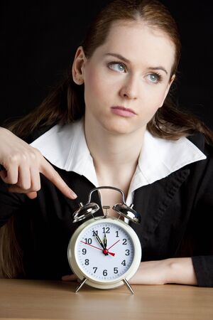 portrait of businesswoman with an alarm clockの写真素材