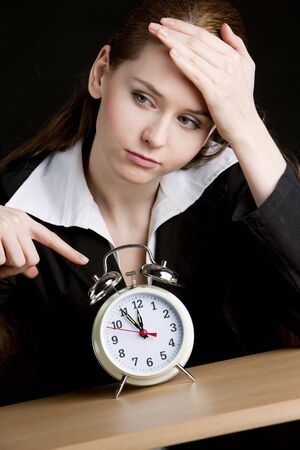 portrait of businesswoman with an alarm clockの写真素材