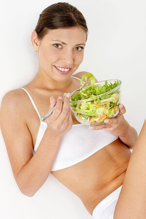 portrait of woman eating saladの写真素材