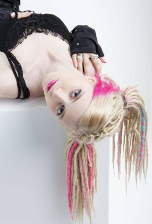portrait of lying young woman with dreadlocksの写真素材