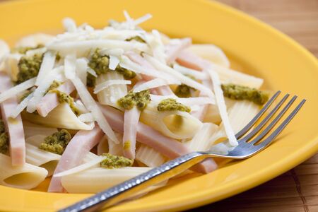 penne with ham and green pestoの写真素材