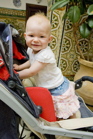 toddler standing in a pram on walk
