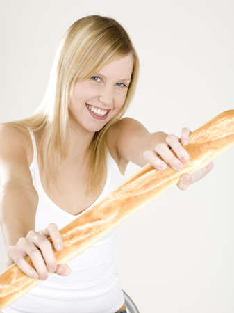 portrait of woman holding a baguetteの写真素材