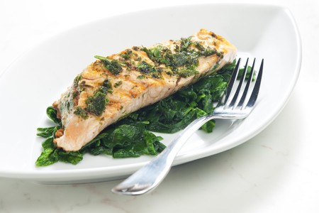 grilled salmon with herbs on fried spinachの写真素材