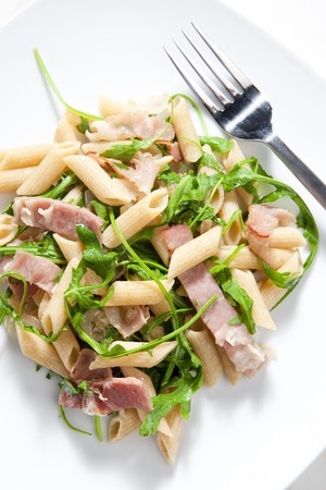 penne pasta with Parma ham and ruccolaの写真素材