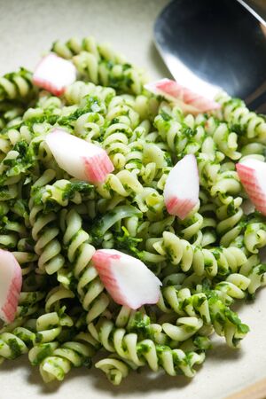 pasta fussili with crab sticks and spinachの写真素材