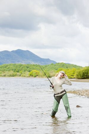 fishing woman, Loch Venachar, Trossachs, Scotlandの写真素材