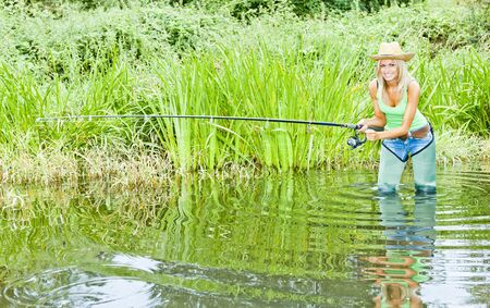 woman fishing in pondの写真素材
