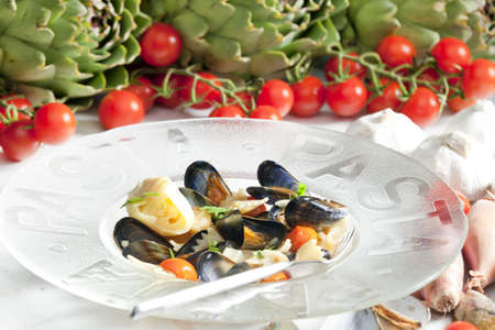 pasta with mussels, artichokes and cherry tomatoesの写真素材