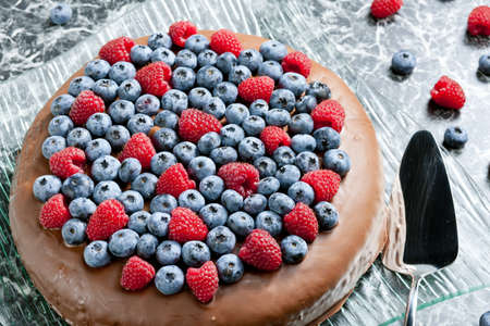 chocolate cake with raspberries and blueberriesの写真素材
