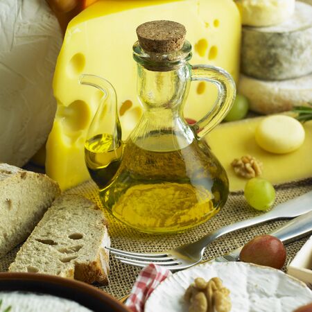cheese still life with olive oilの写真素材